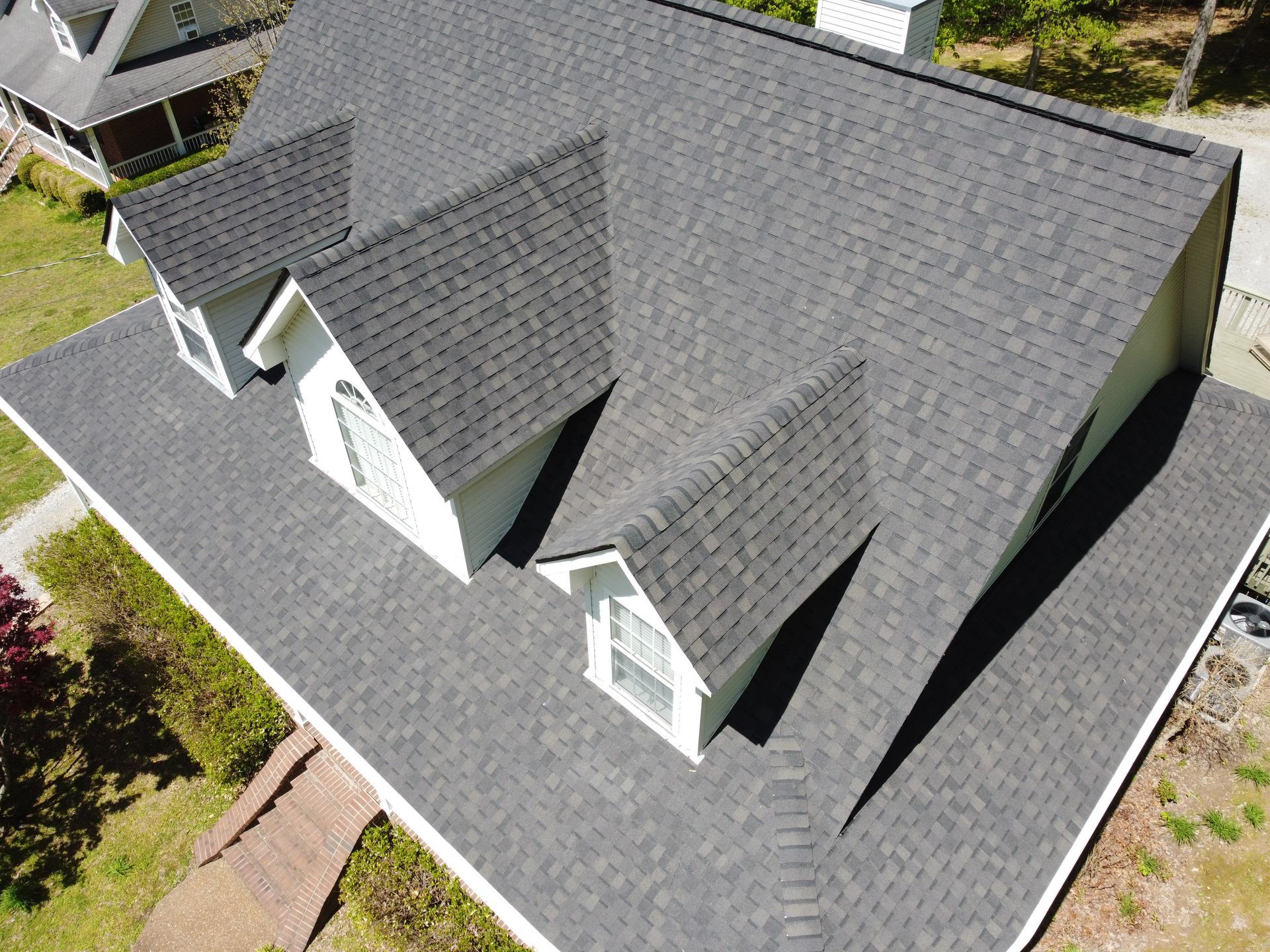 An aerial view of a house with a gray roof.