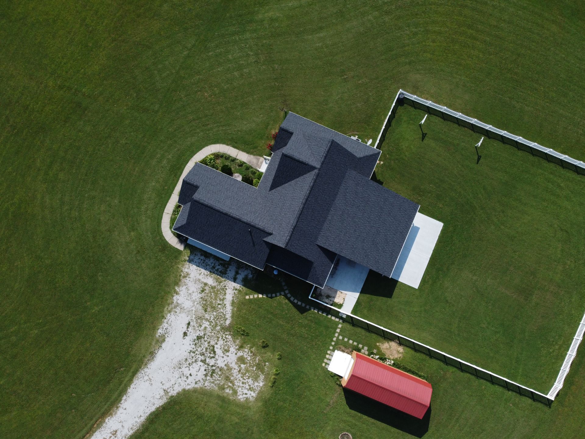 An aerial view of a house and a red barn