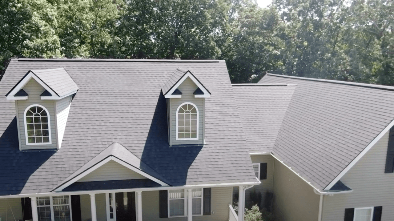 An aerial view of a house with a blue roof