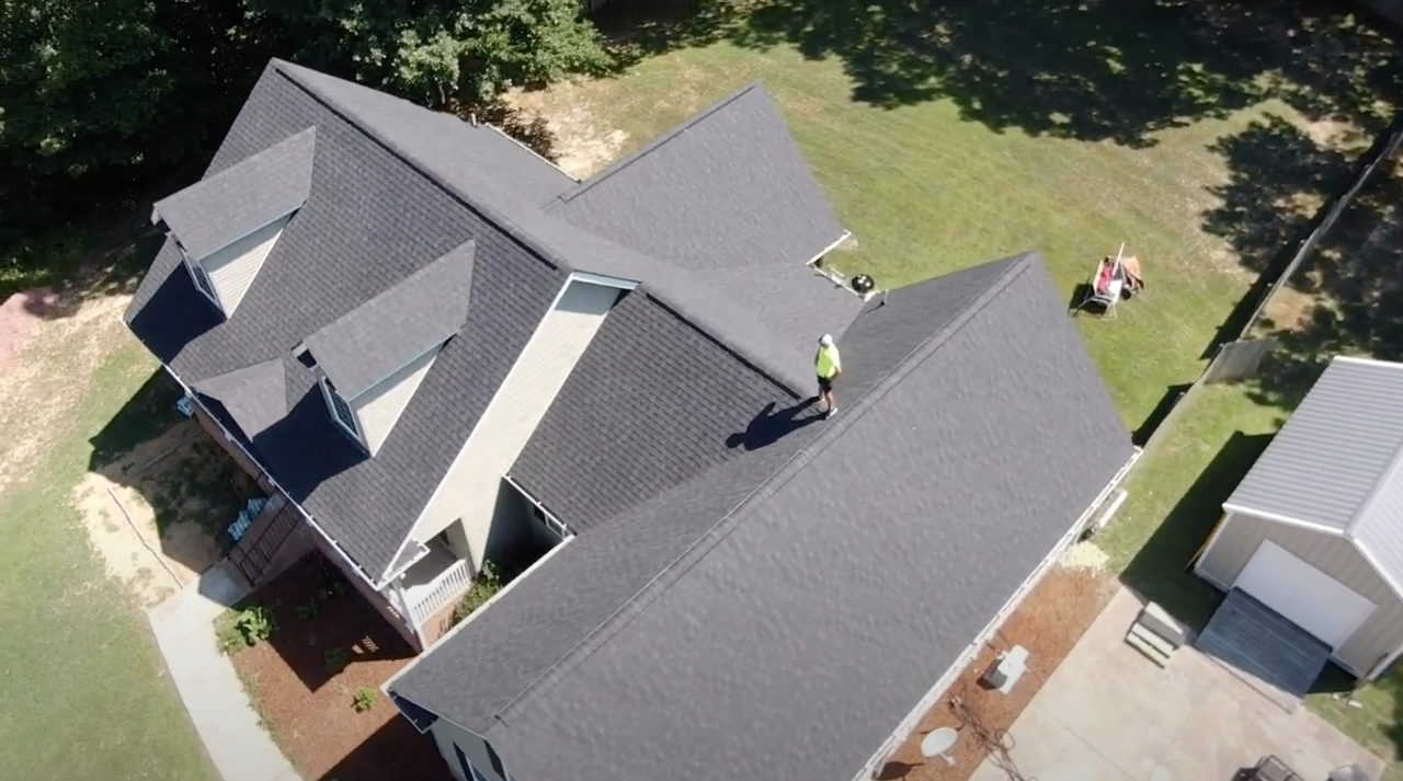 An aerial view of a house with a roof being installed.