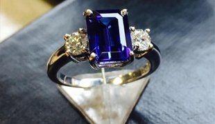 blue stone with diamonds on an engagement ring