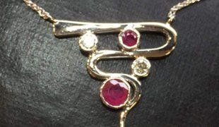 a chain pendant with red and white stones