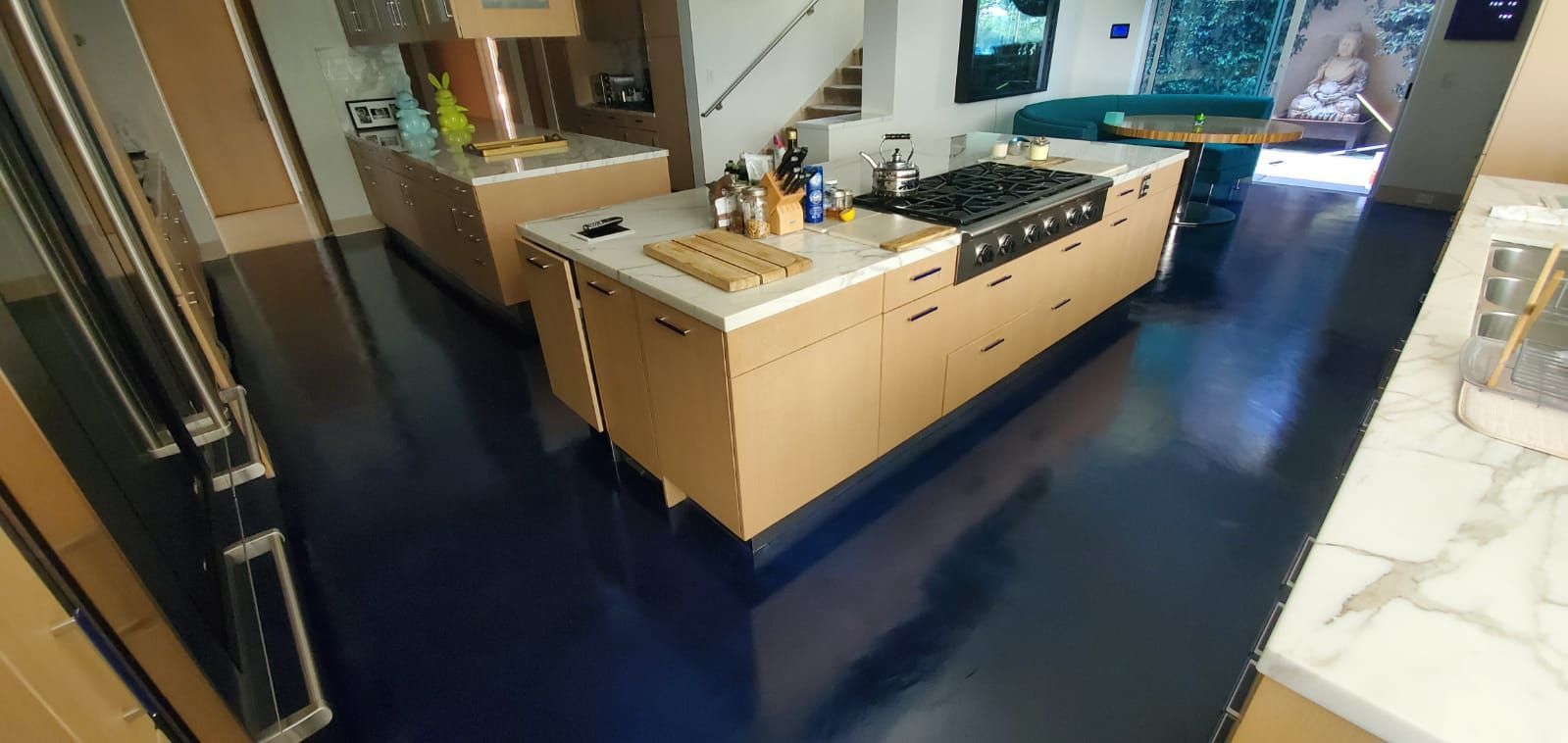 A kitchen with a large island and a stove top oven.