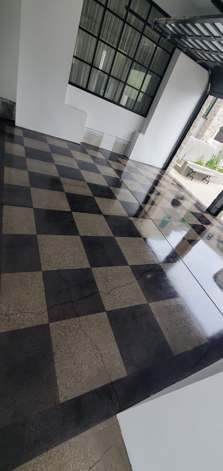 A room with a checkered floor and a window.