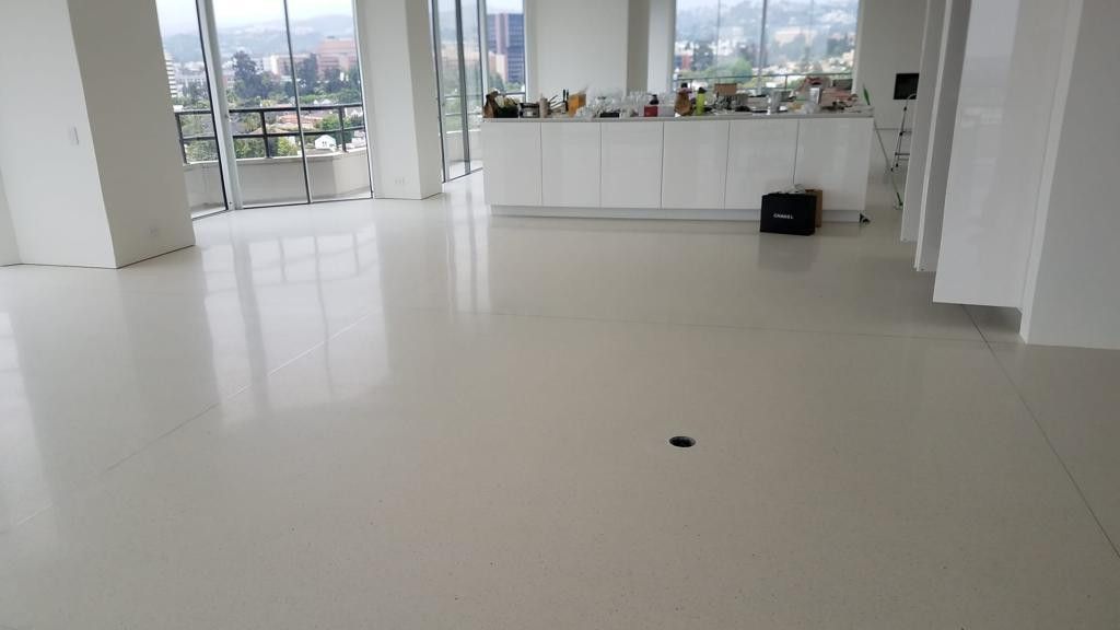 A large room with a lot of windows and a white floor.