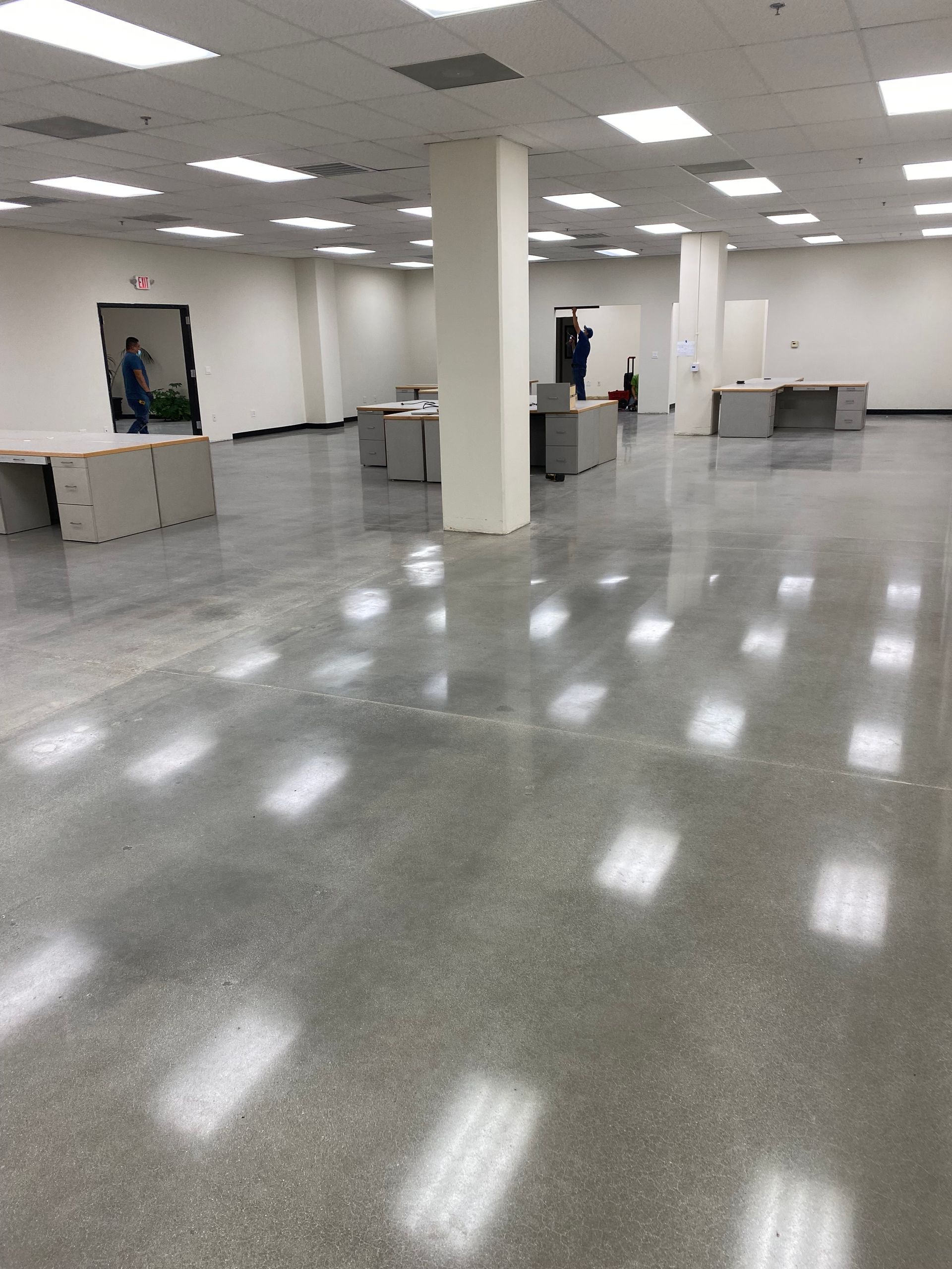 A large room with a shiny floor and white walls