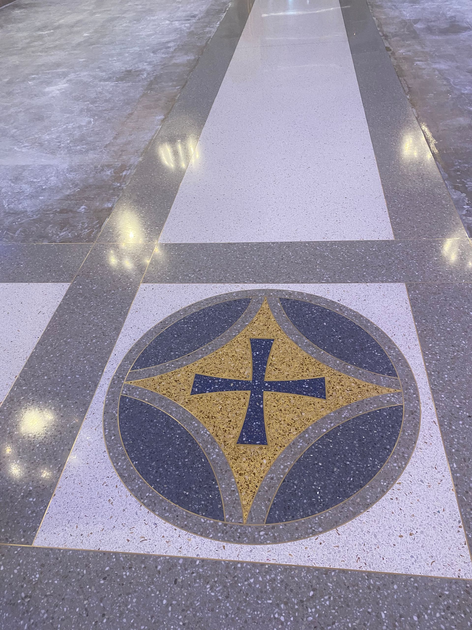 A cross in a circle on a tiled floor