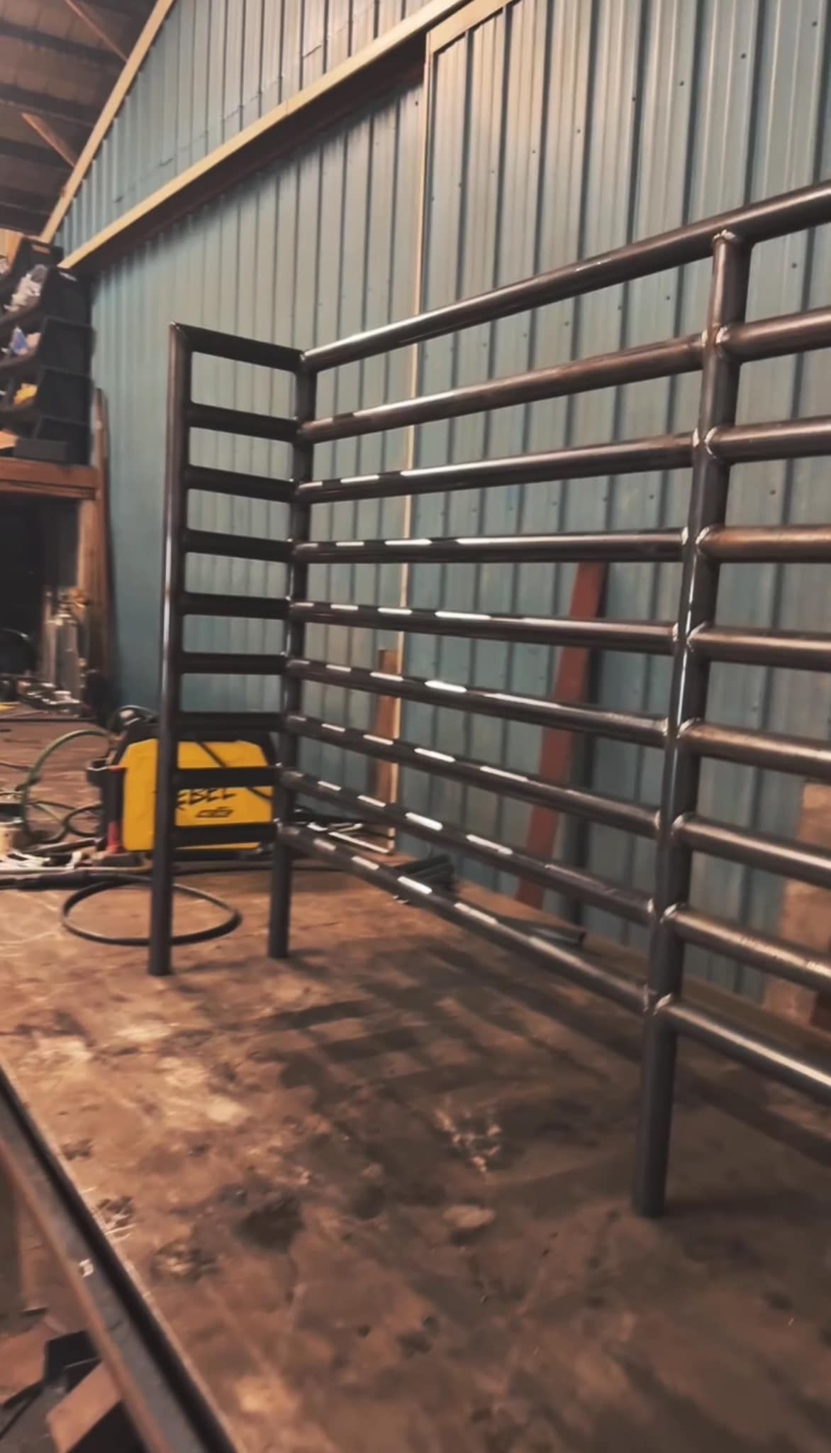 A wooden fence is sitting on top of a lush green field.