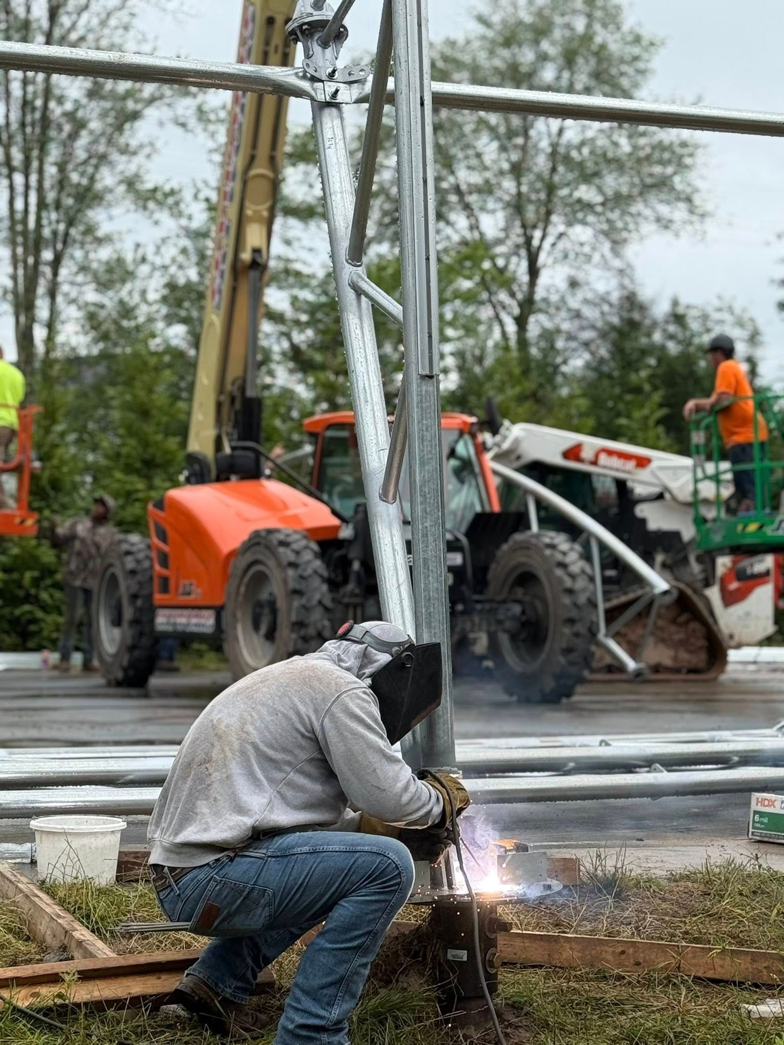 A wooden fence is sitting on top of a lush green field.