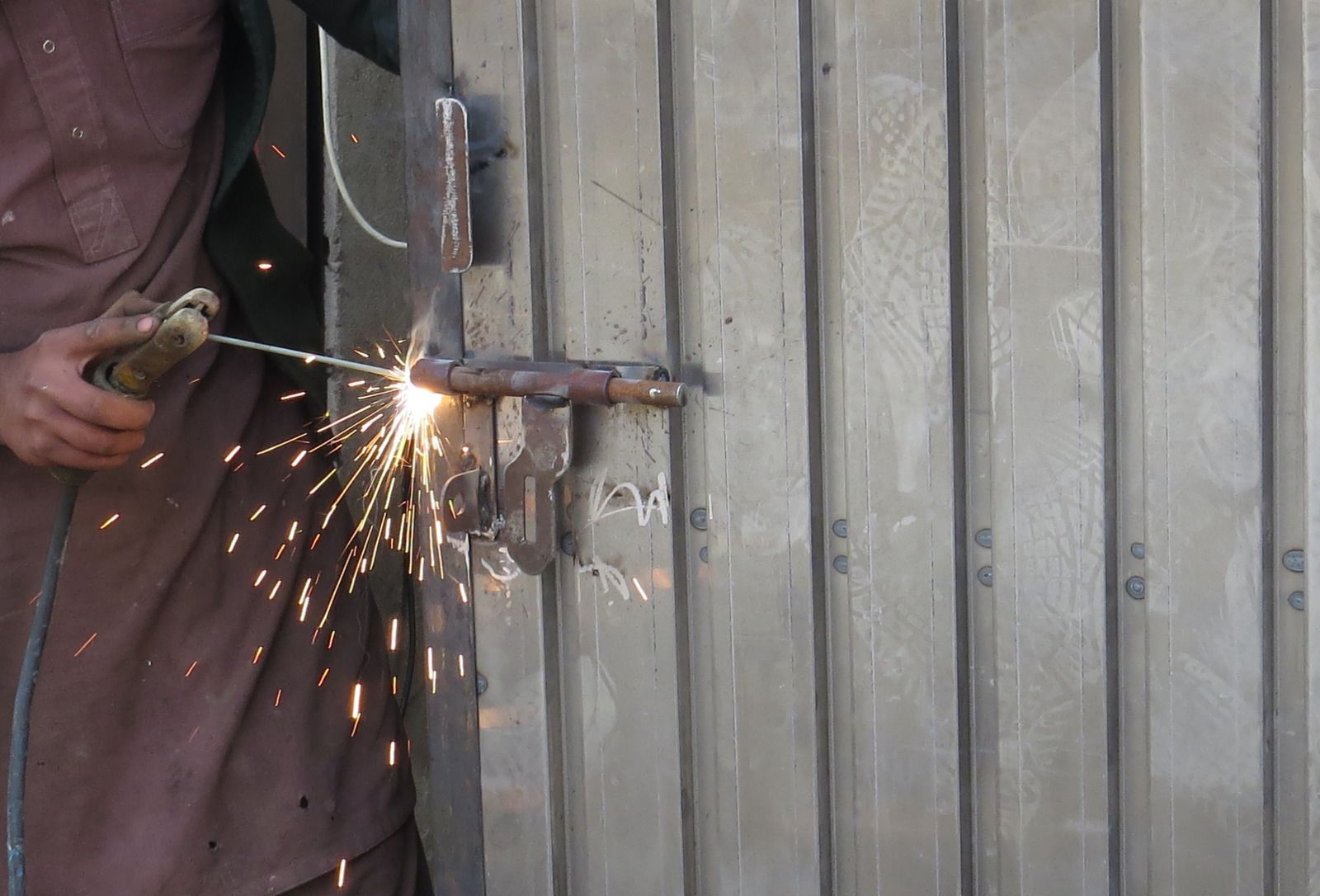 A wooden fence is sitting on top of a lush green field.