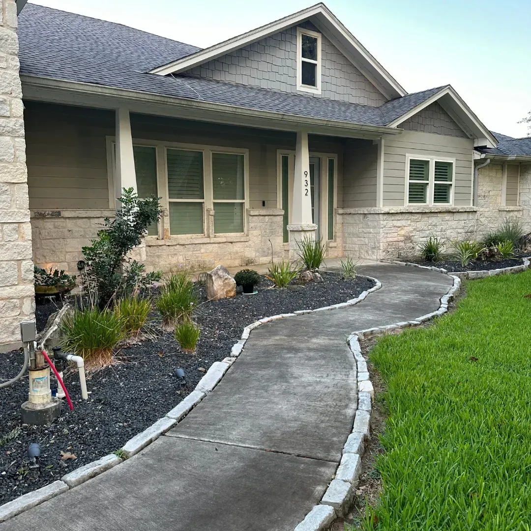 A house with a concrete walkway leading to it