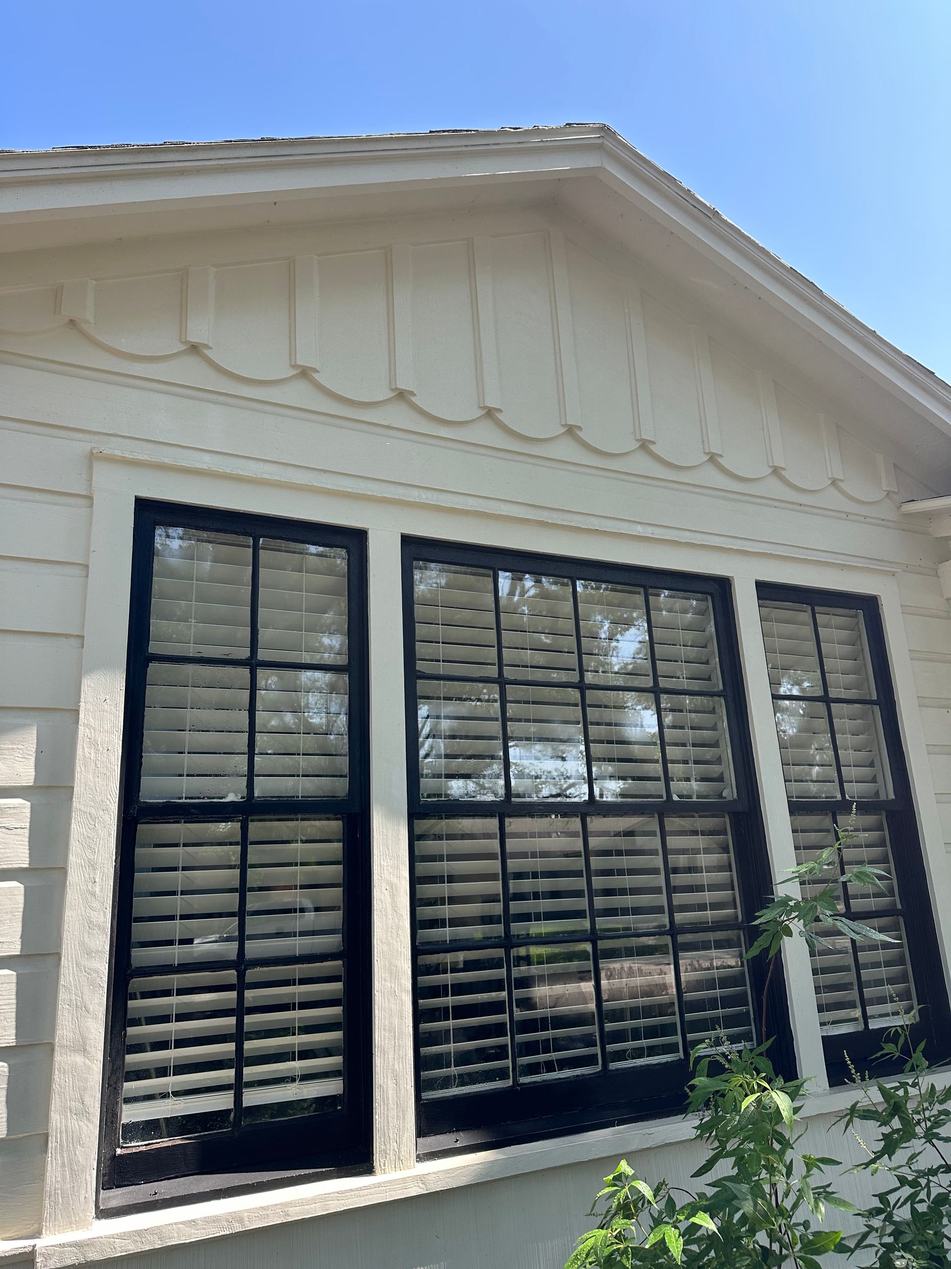 A white house with black shutters on the windows