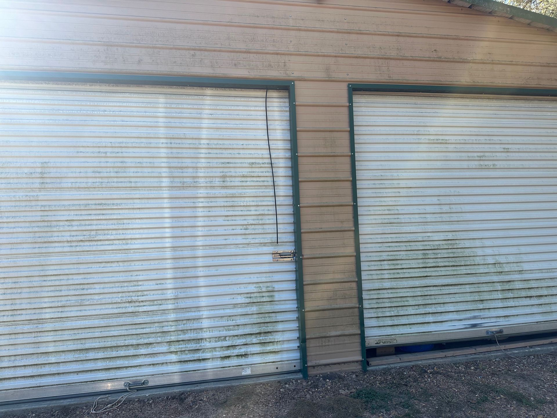 A garage with a broken garage door and a broken window