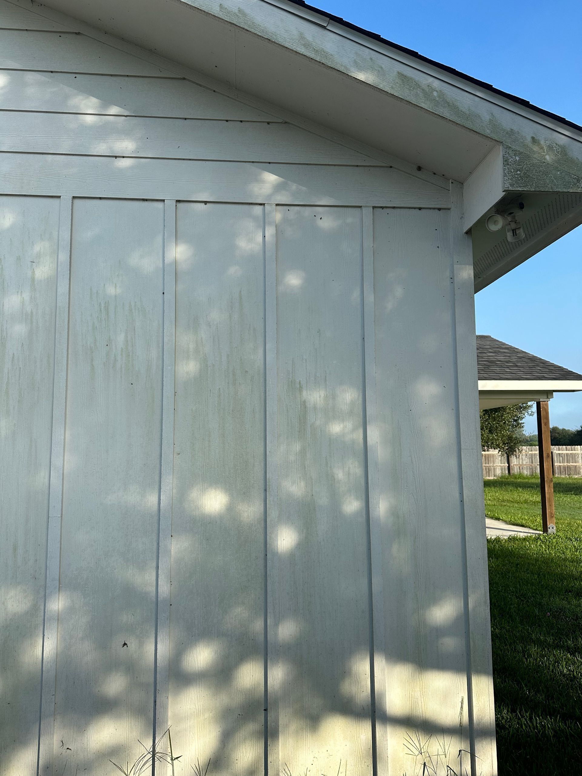 A white building with a blue sky in the background