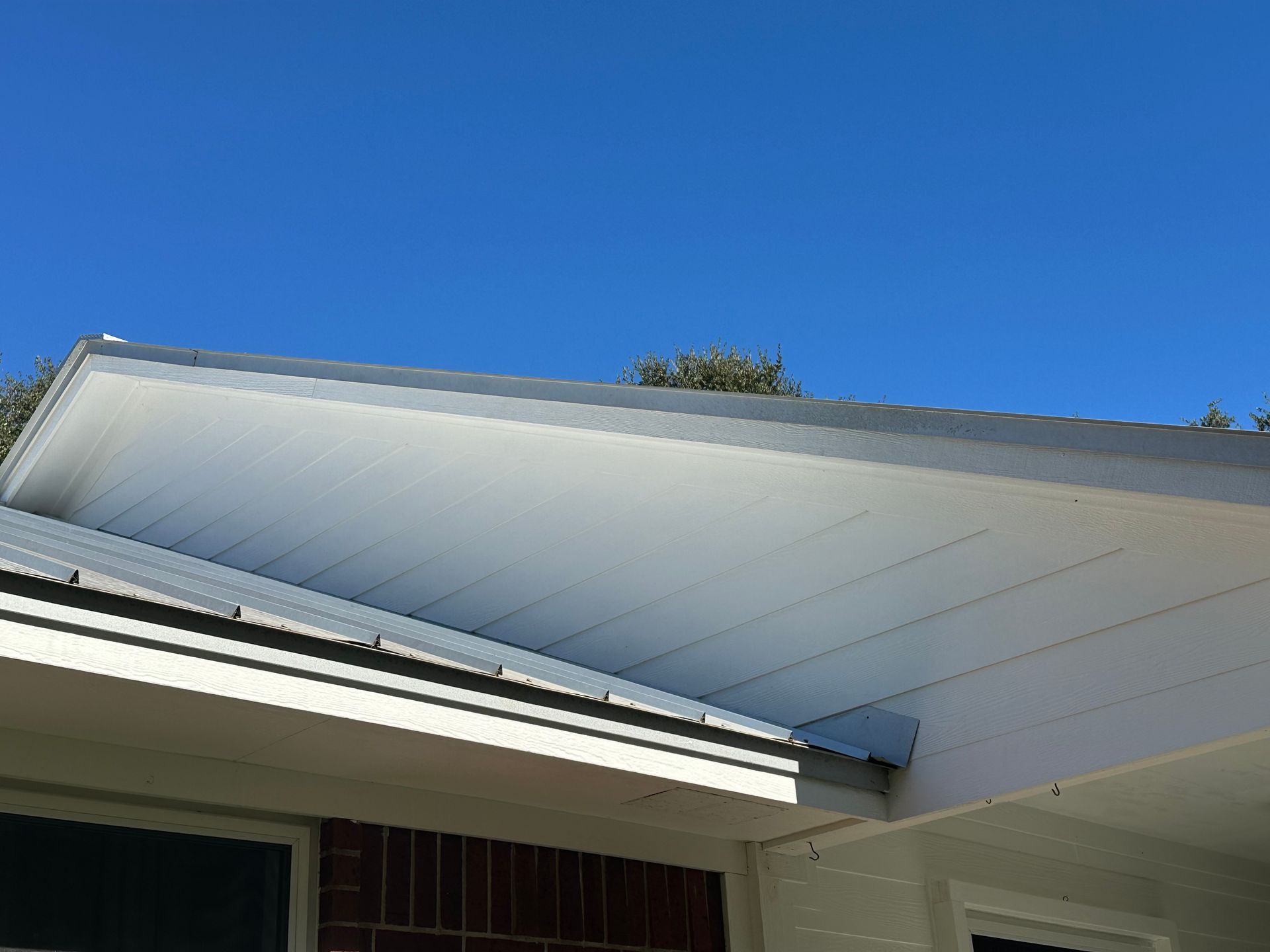A white roof with a blue sky in the background