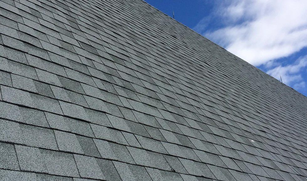 Un gros plan d'un toit avec un ciel bleu en arrière-plan.