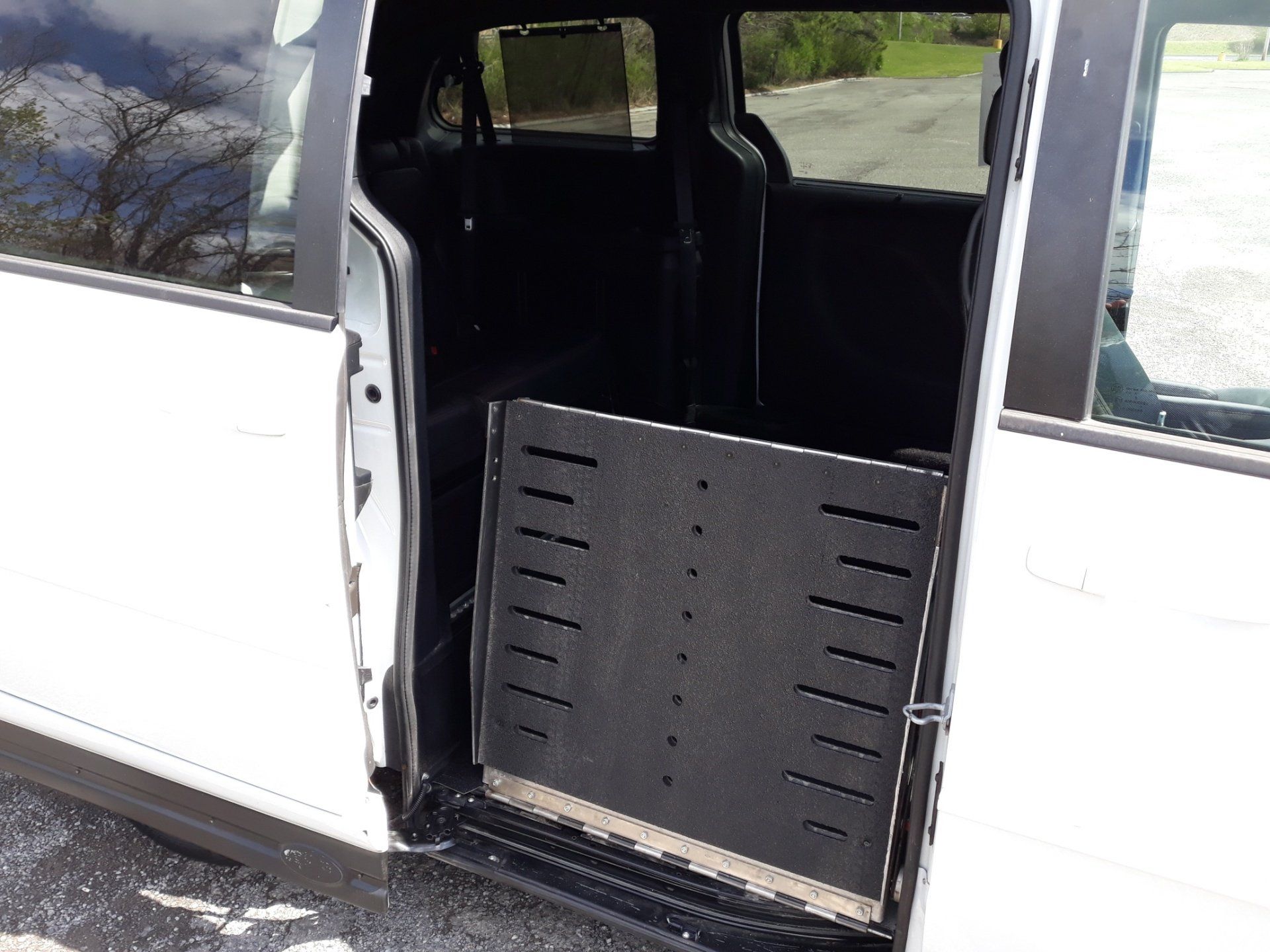 A white van with a ramp in the back door