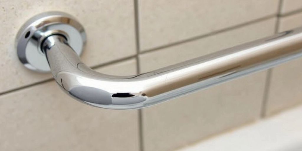 Close-up of a chrome grab bar in a bathroom.