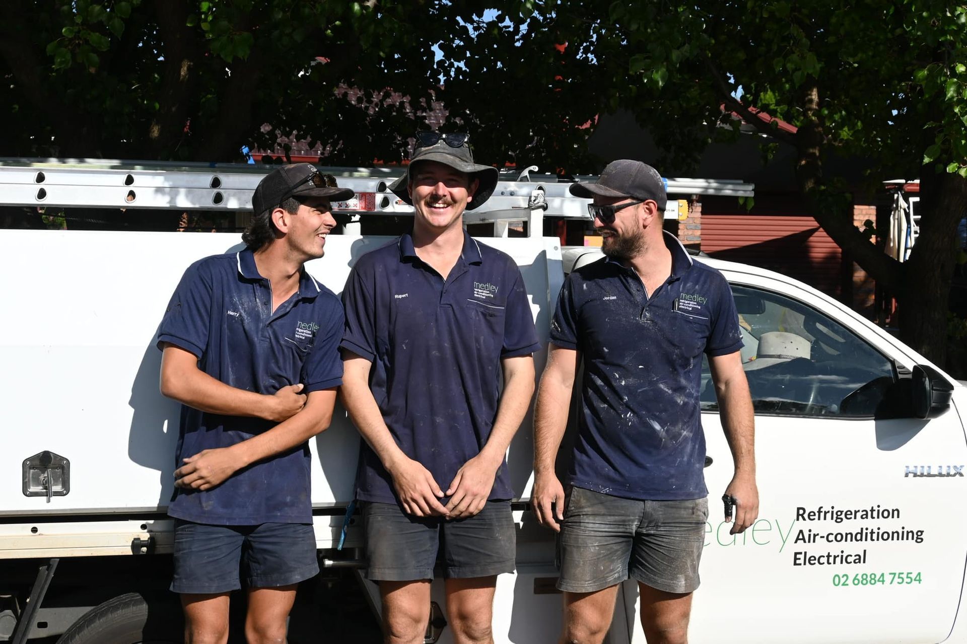 Three tradesmen in front of Medley ute