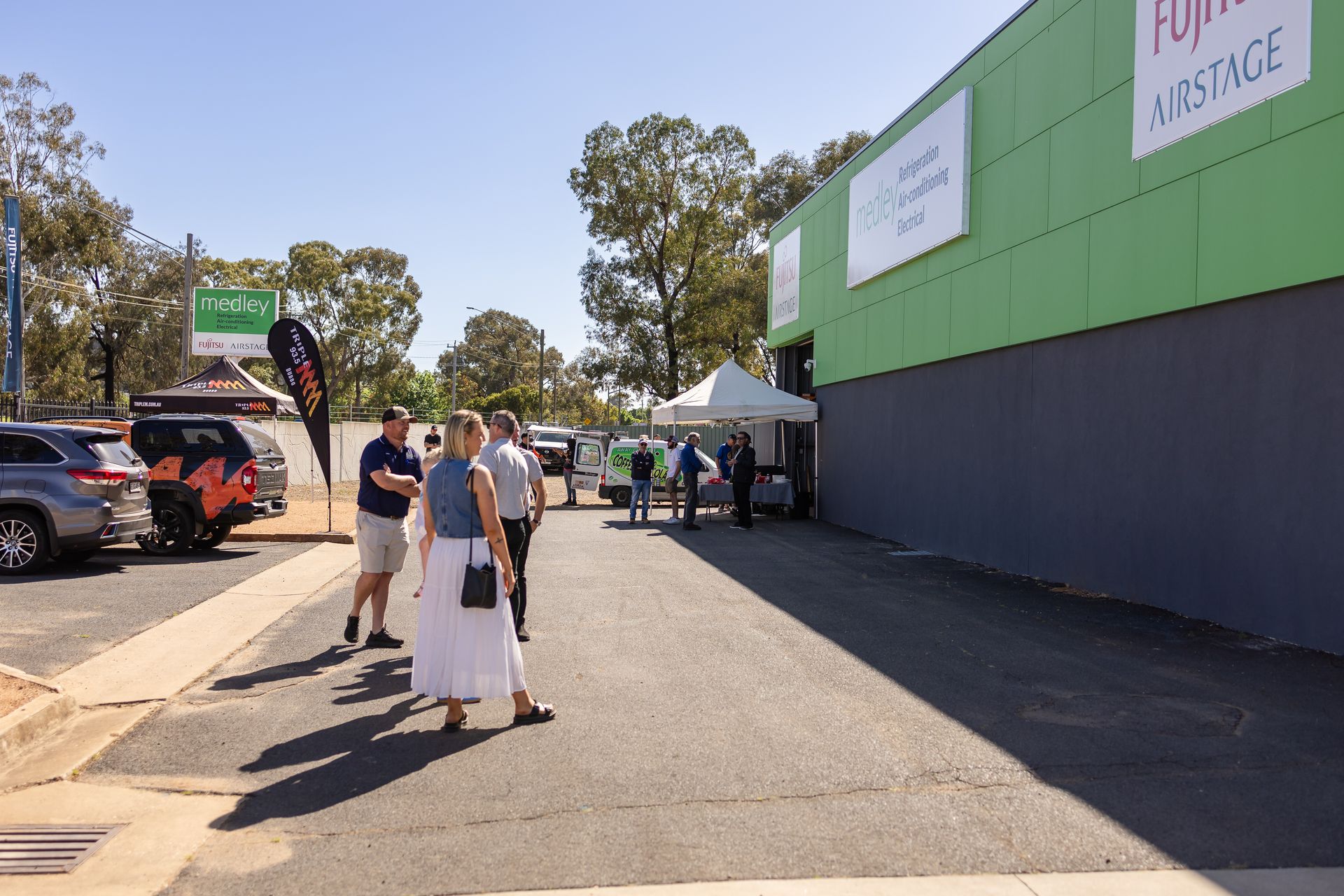A group of people standing in front of Medley Refrigeration and Air Conditioning