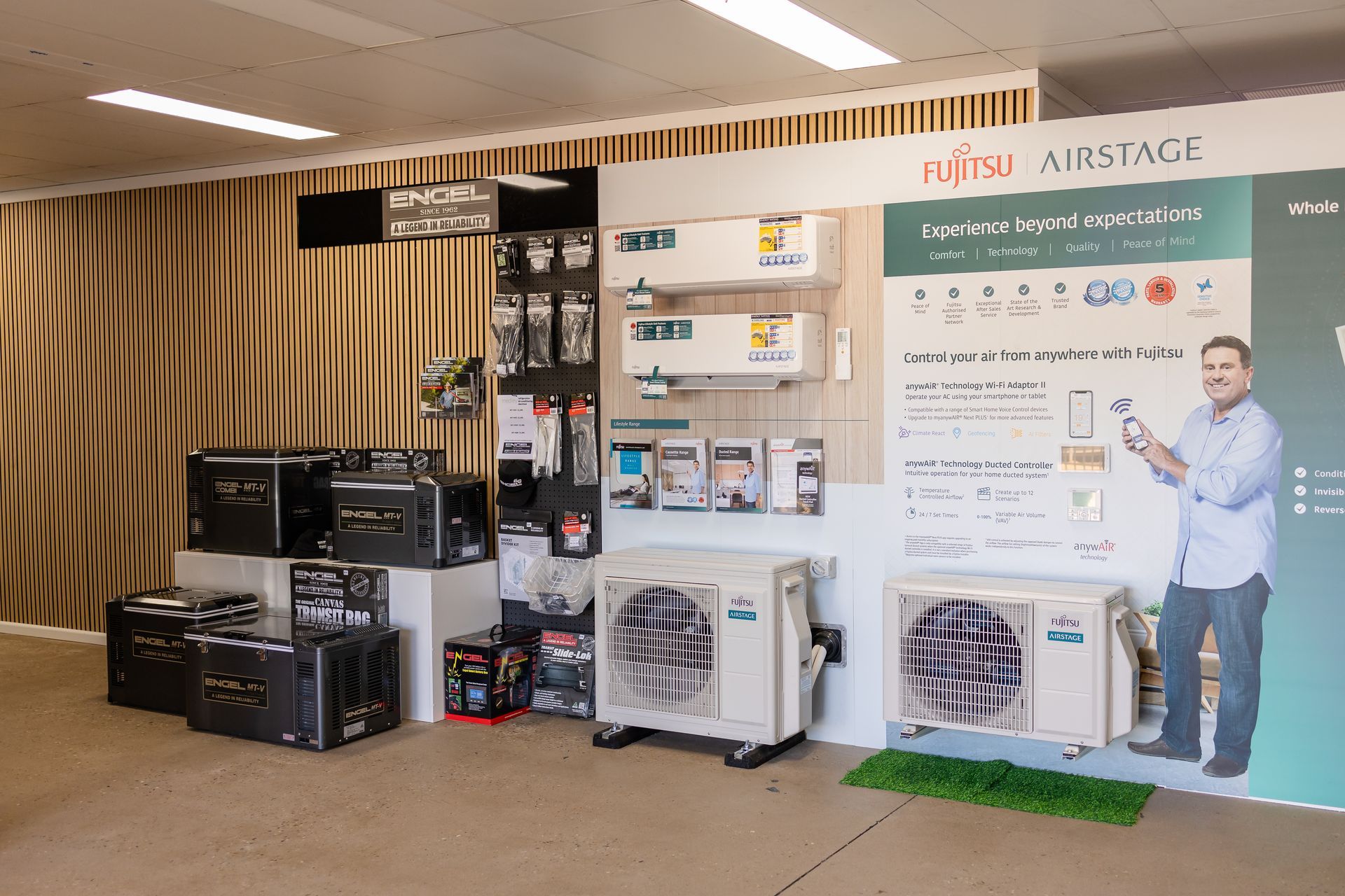 A showroom filled with a variety of refrigerators and air conditioners.