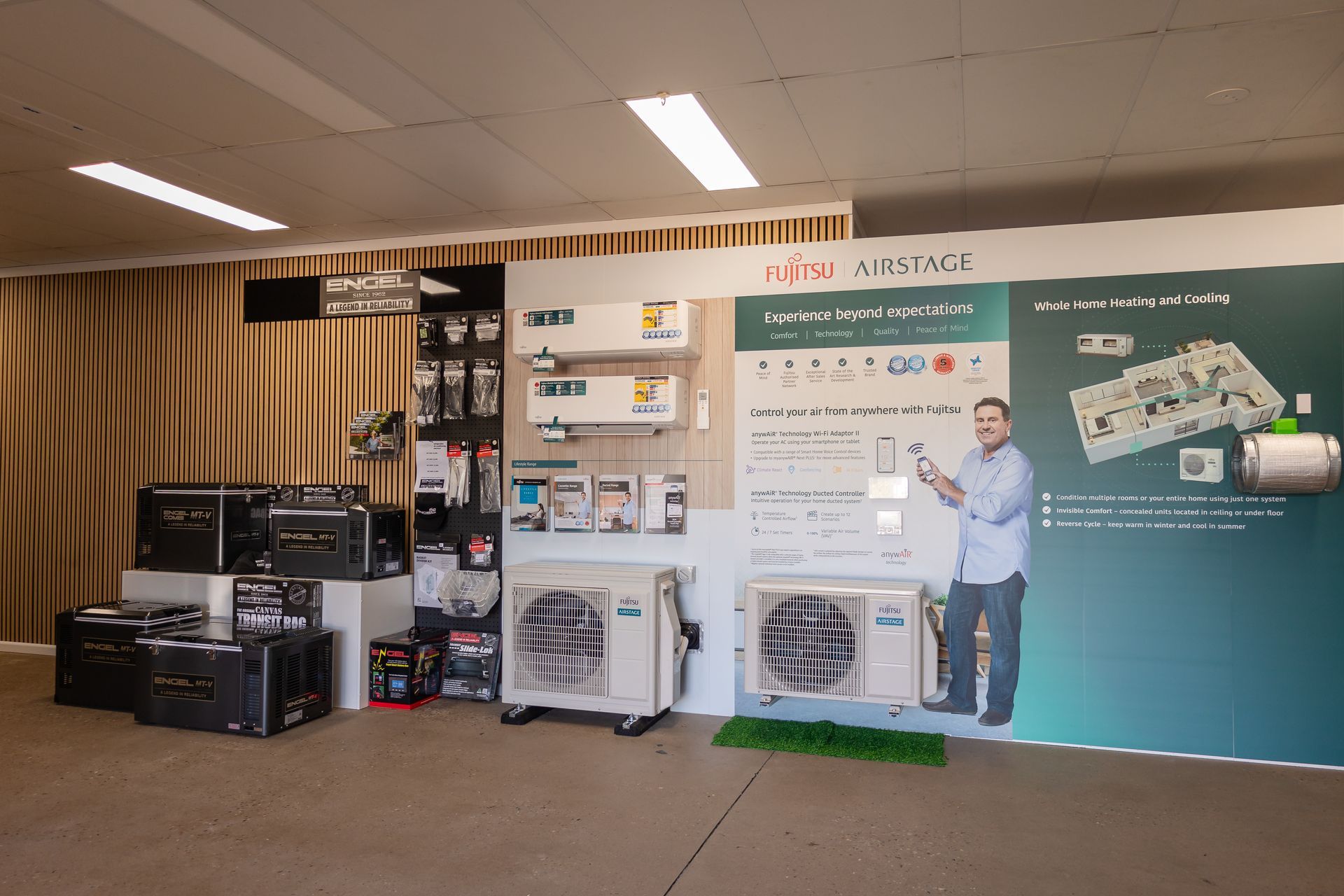 A showroom filled with a variety of refrigerators and air conditioners.