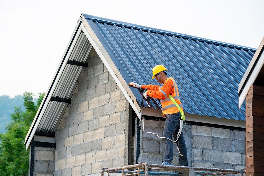 worker repairing the roof of the house