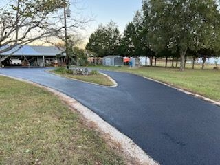 A newly paved driveway leading to a house