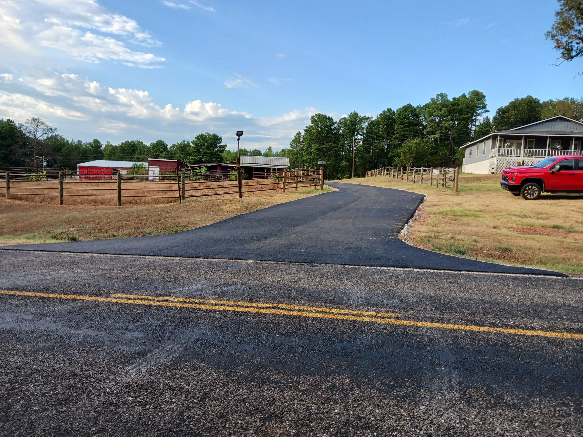A red car is parked on the side of the road