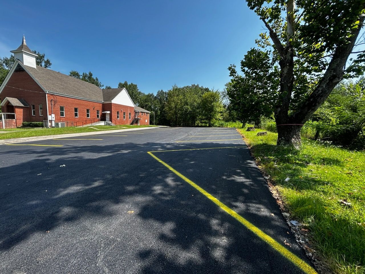 A church with a yellow line on the road in front of it