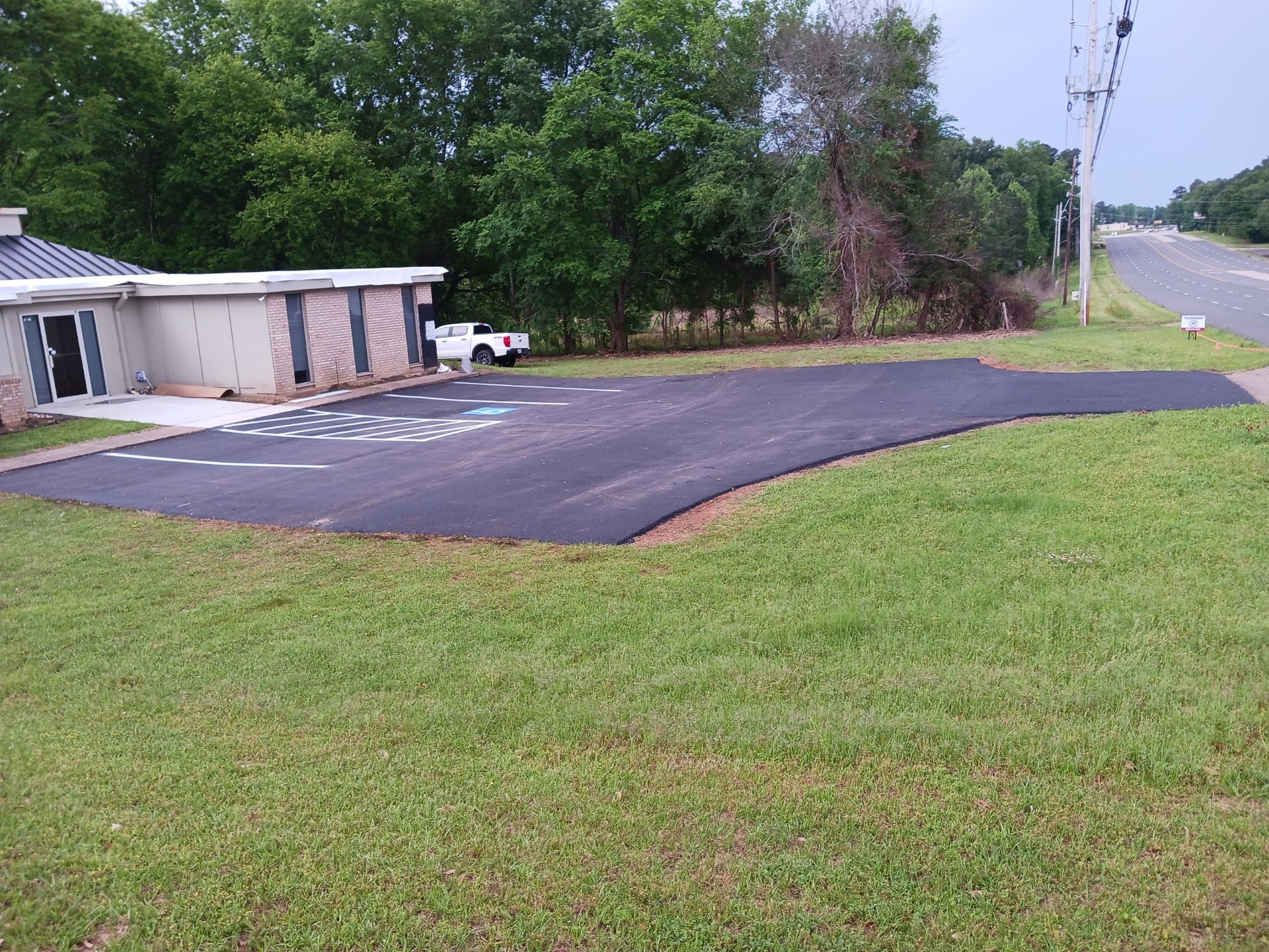 A parking lot with a handicapped parking spot in front of a house