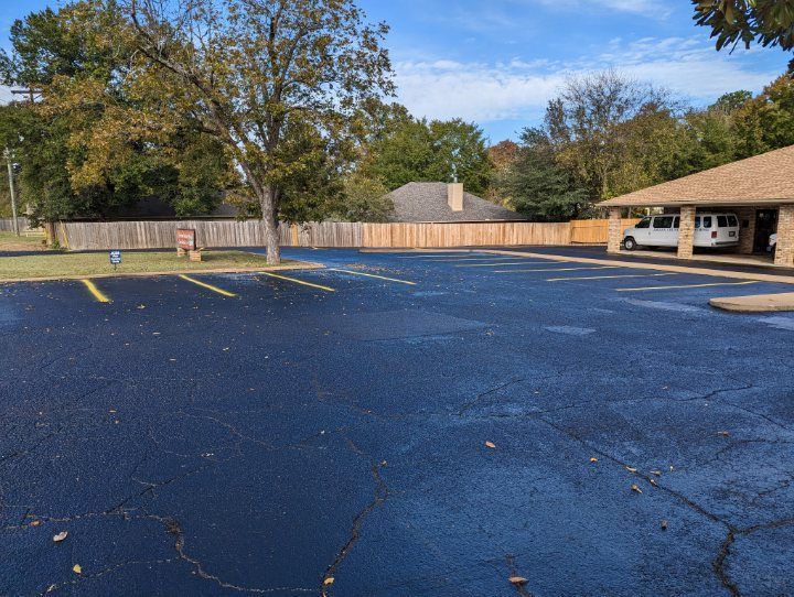 A parking lot with a white van parked in it