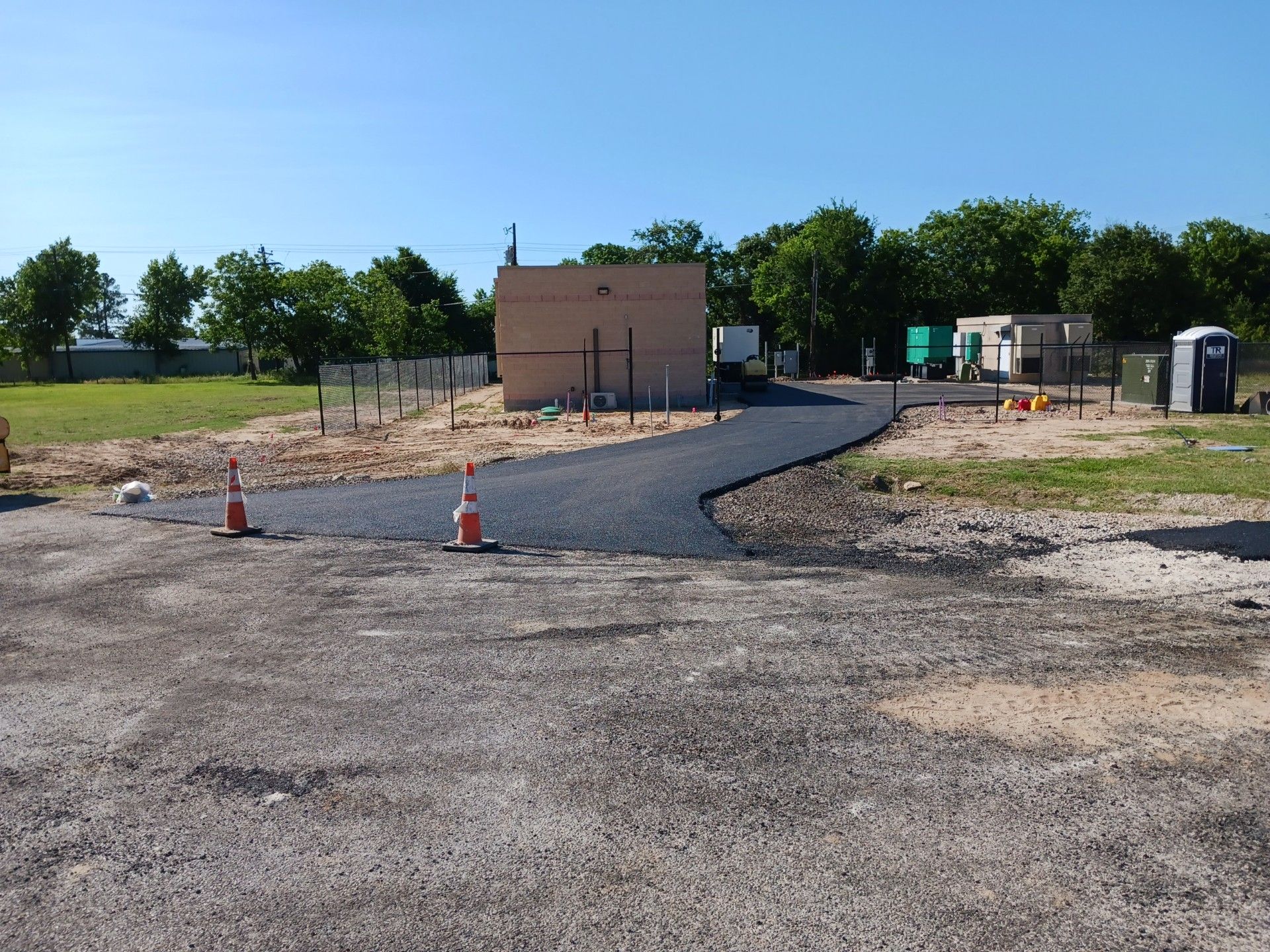 A construction site with a building in the background