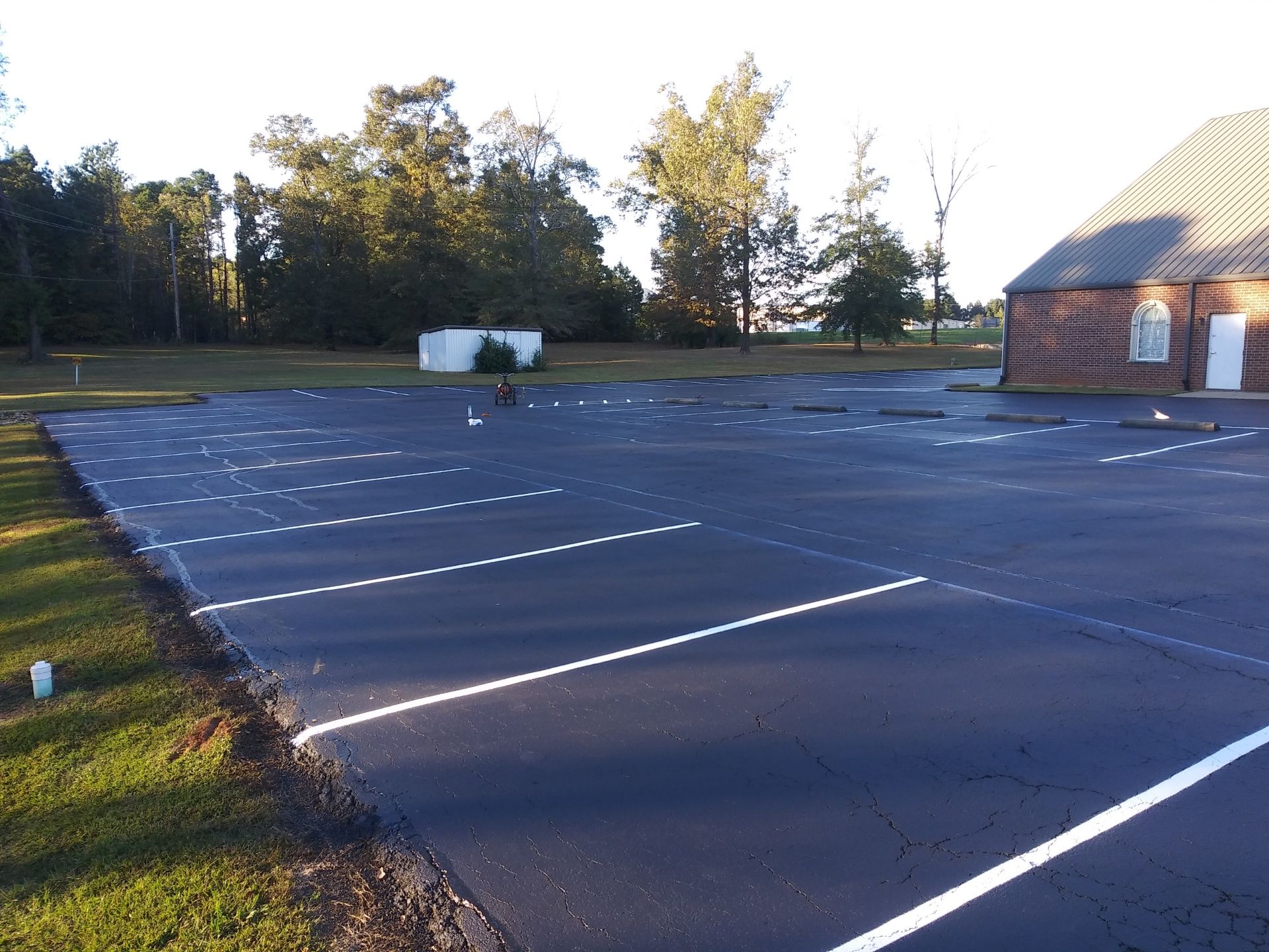 A large parking lot with a church in the background