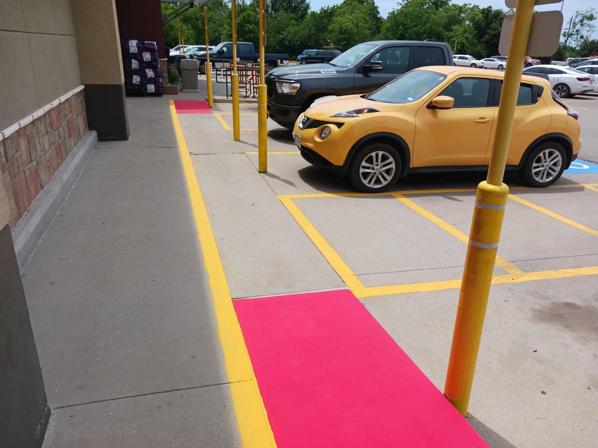 A yellow car is parked in a parking lot