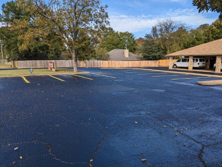 A parking lot with a white van parked in it