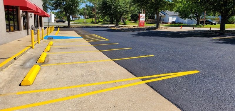 A parking lot with yellow lines painted on the side of it