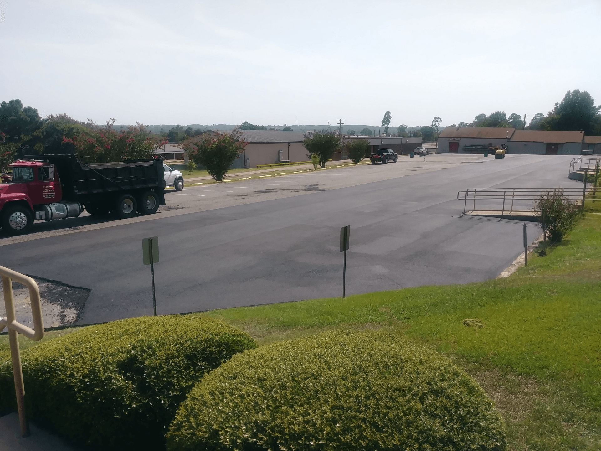 A red dump truck is parked in a parking lot