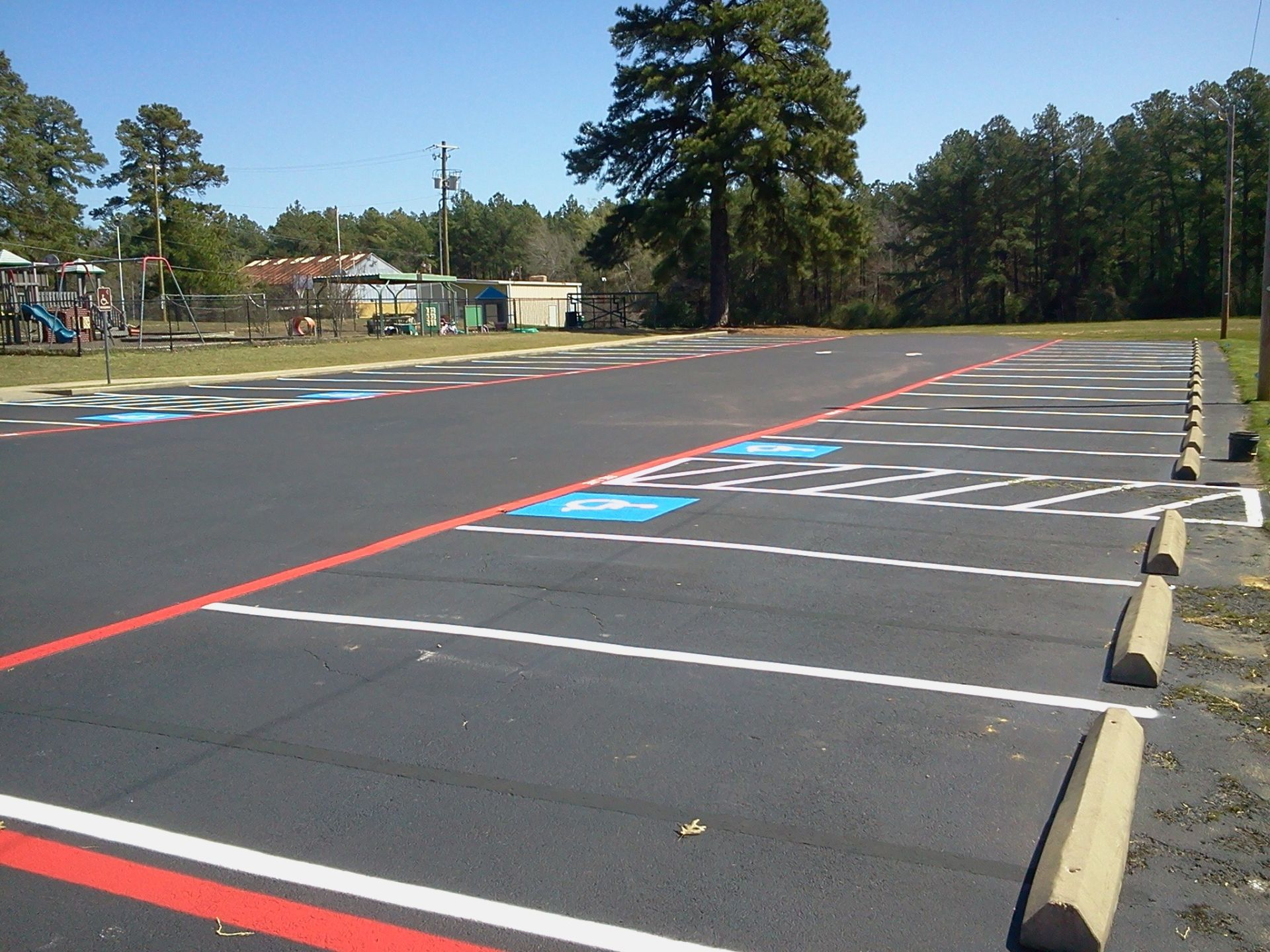 A parking lot with a few trees in the background