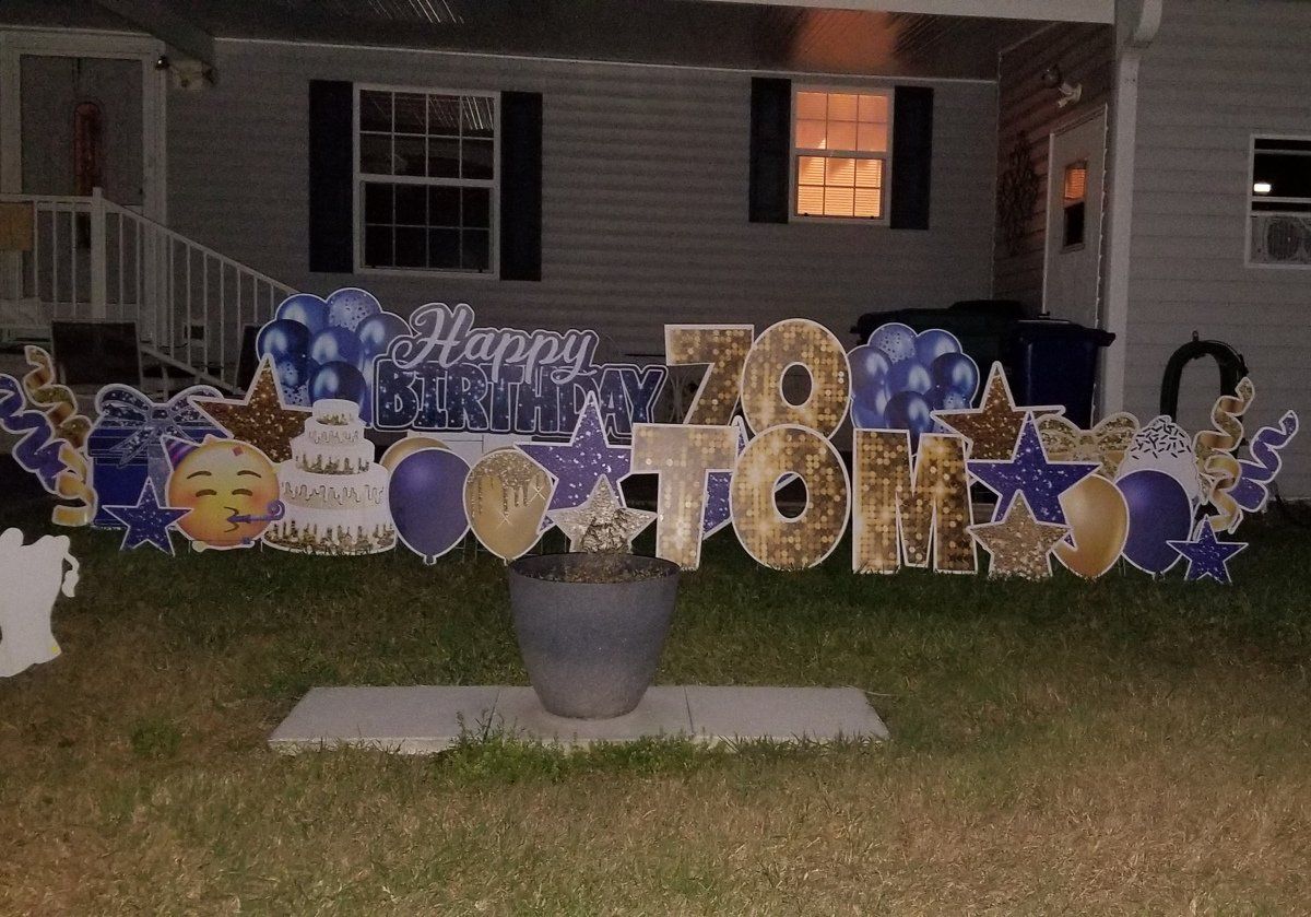 Big letters in yard spelling out Happy Birthday with a name and age