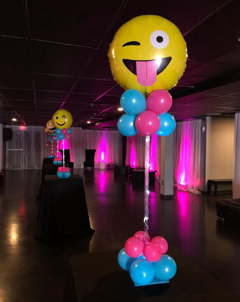 pink and blue table centerpiece with lg emoji topper