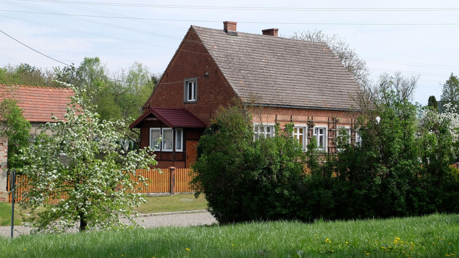 A brick house with a roof that is covered in shingles