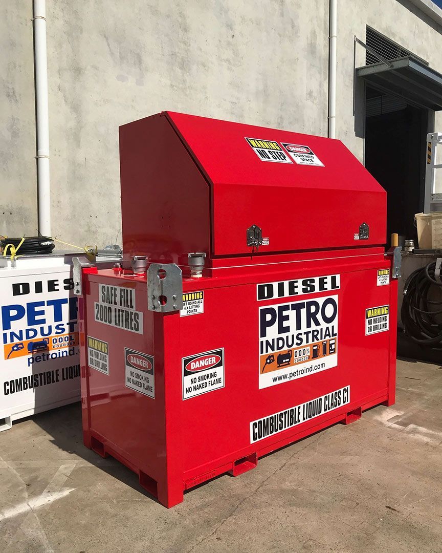 A Red Diesel Petro Industrial Tank Is Sitting in Front of A Building — Wades Distributors In Darwin, NT