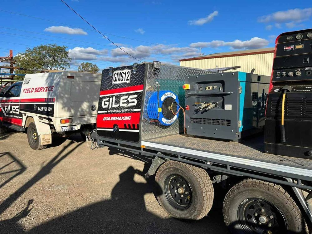 A Truck with A Trailer Attached to It Is Parked in A Parking Lot — Wades Distributors In Townsville, QLD