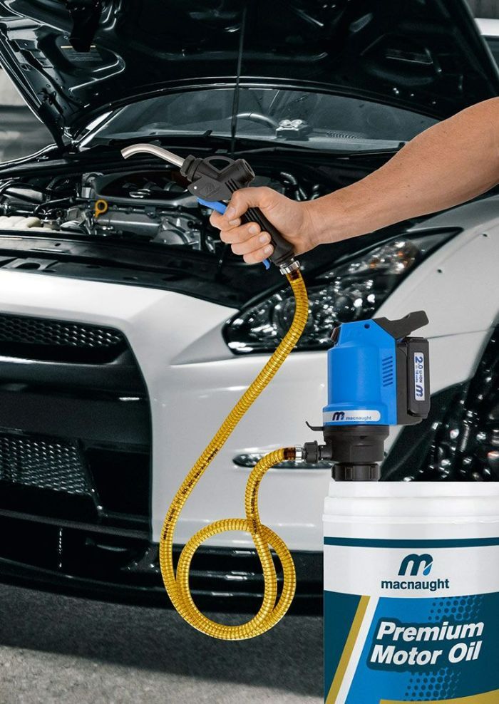 A Person Is Filling a Car with Premium Motor Oil — Wades Distributors In Mt Isa, QLD