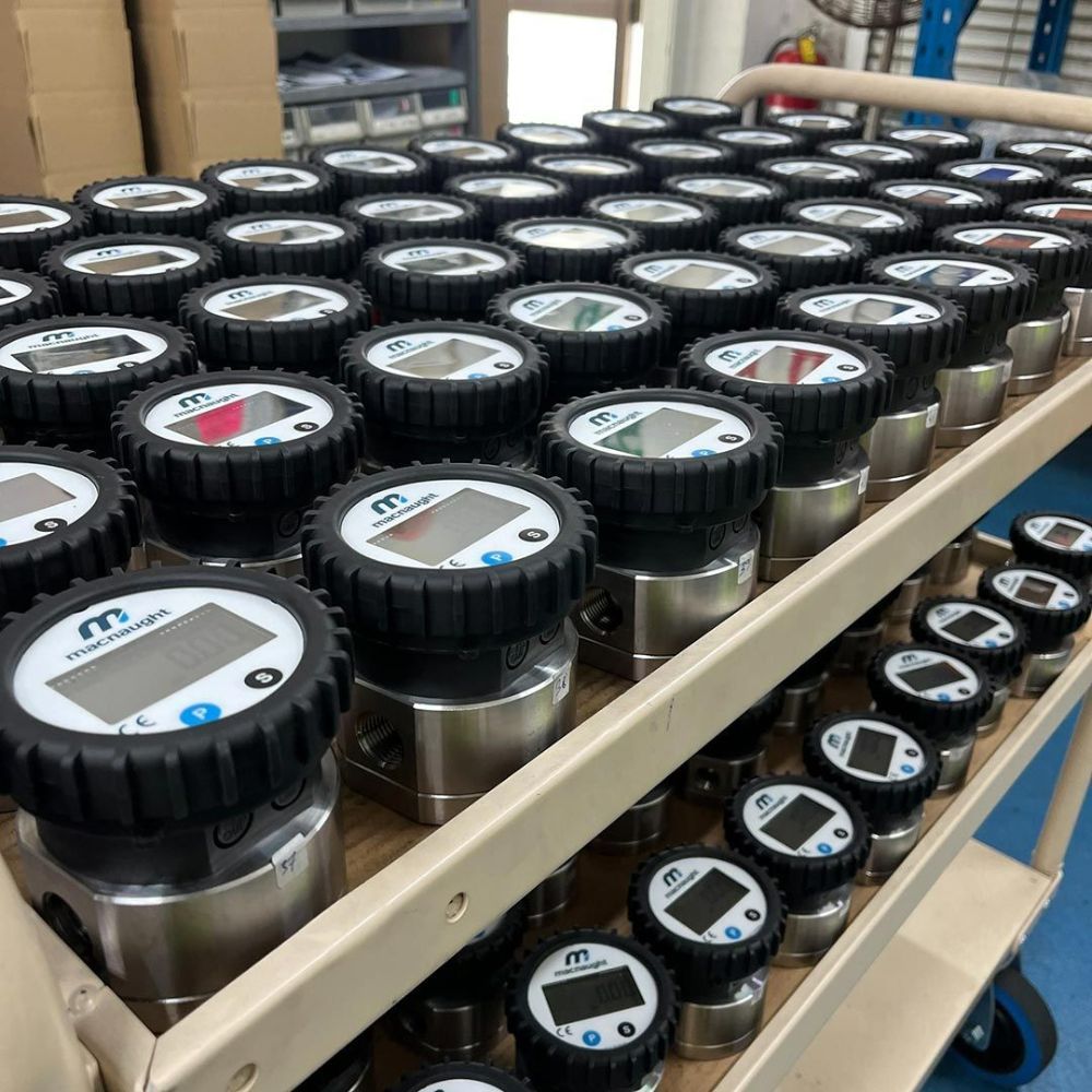 A Cart Filled with Lots of Bottles with Digital Displays on Them — Wades Distributors In Garbutt, QLD