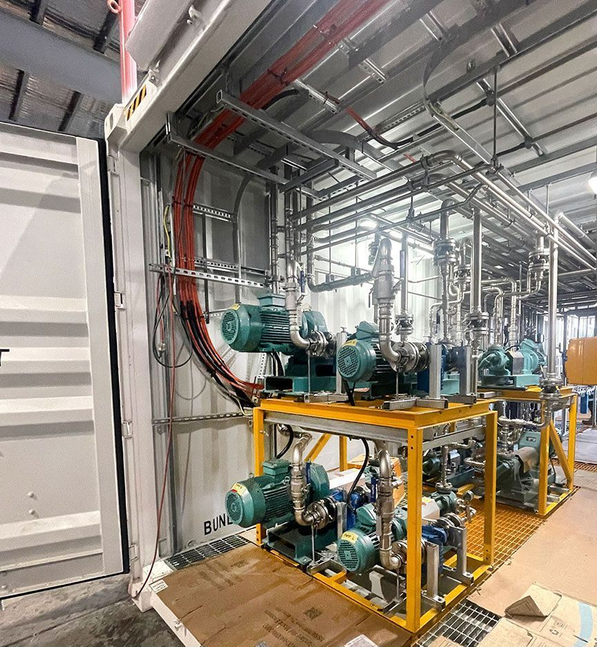 A Warehouse Filled with Lots of Machinery and Pipes — Wades Distributors In Townsville, QLD