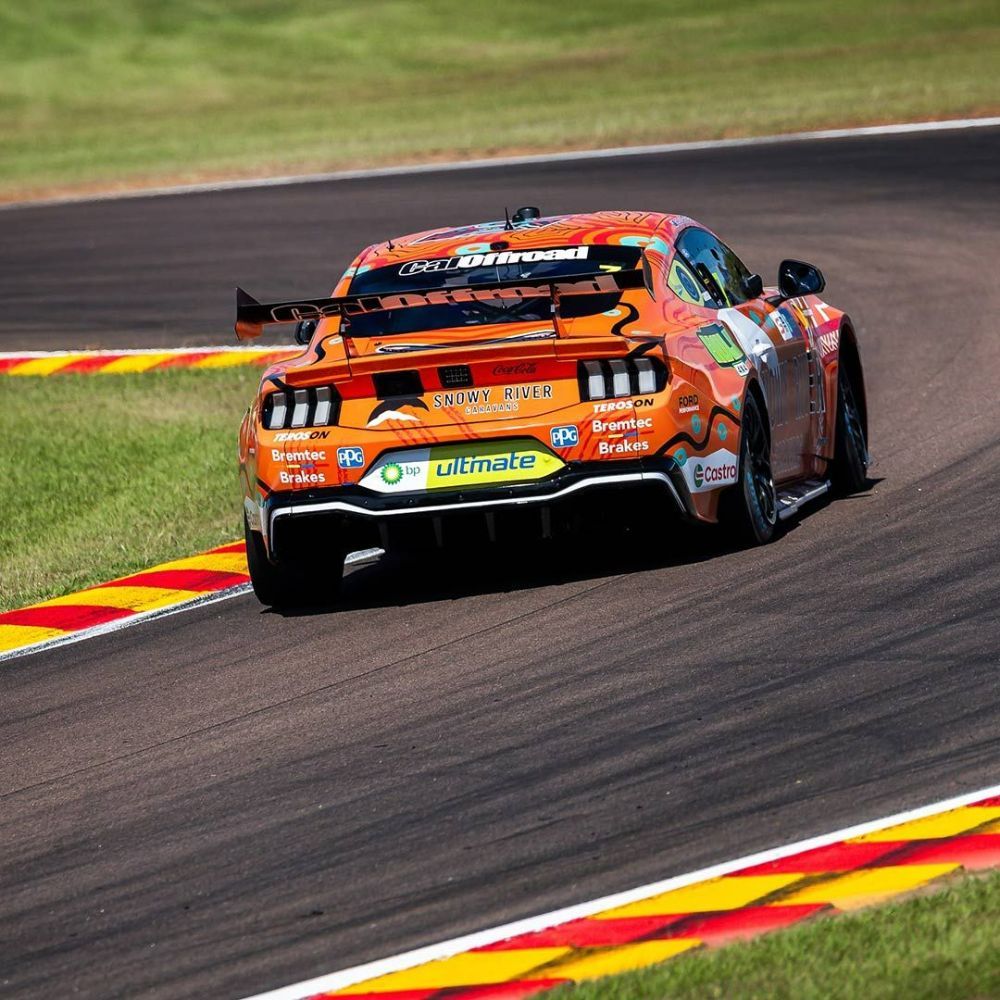 A Race Car Is Driving Down a Race Track — Wades Distributors In Whitsundays, QLD