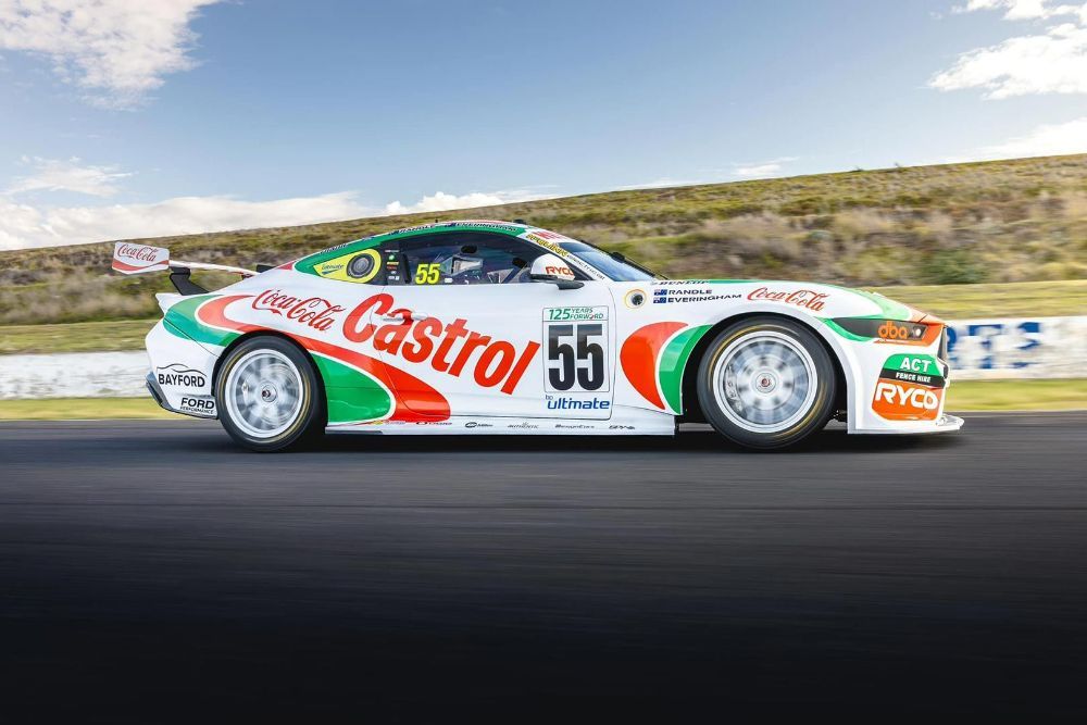 A Racing Car Is Driving Down a Track — Wades Distributors In Garbutt, QLD