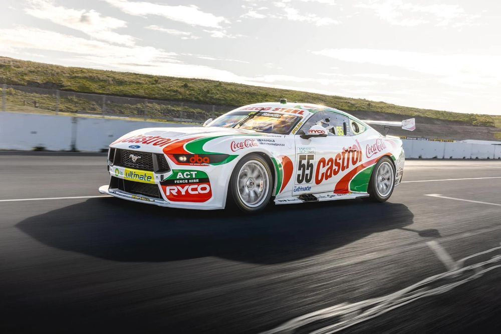 A Racing Car Is Driving Down a Race Track — Wades Distributors In Garbutt, QLD